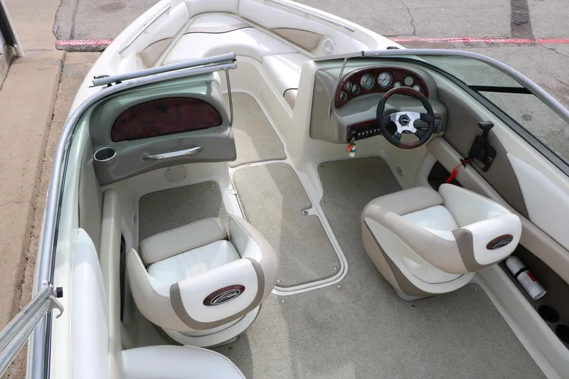 Slide: The Image of 2006 Caravelle 207 Bow Rider interior with beige seating and modern dashboard design. - 29