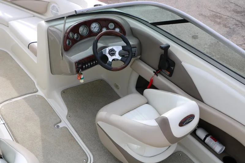 Slide: The Image of Interior of a 2006 Caravelle 207 Bow Rider boat, featuring steering wheel and dashboard controls. - 30