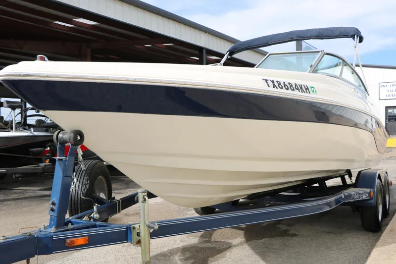 Slide: The Image of 2006 Caravelle 207 Bow Rider boat on trailer, parked outdoors. - 5