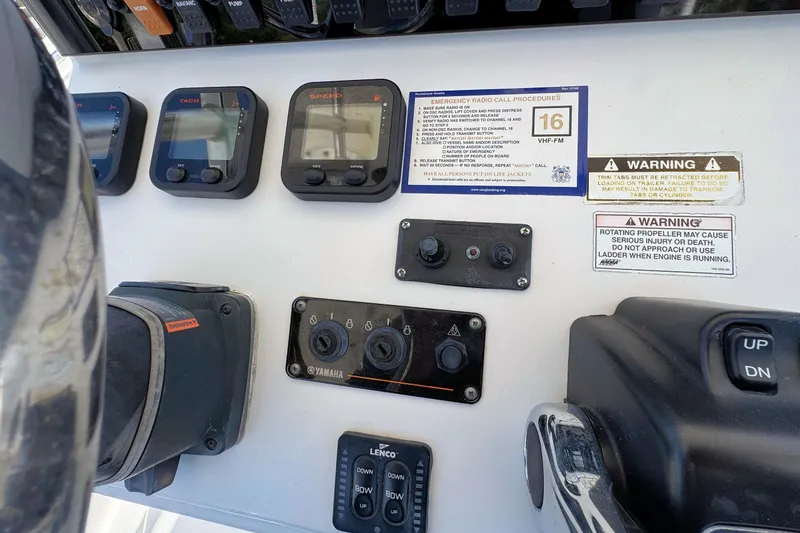 Slide: The Image of Control panel of a 2011 Sea Hunt Gamefish 25 boat with gauges and warning labels. - 11