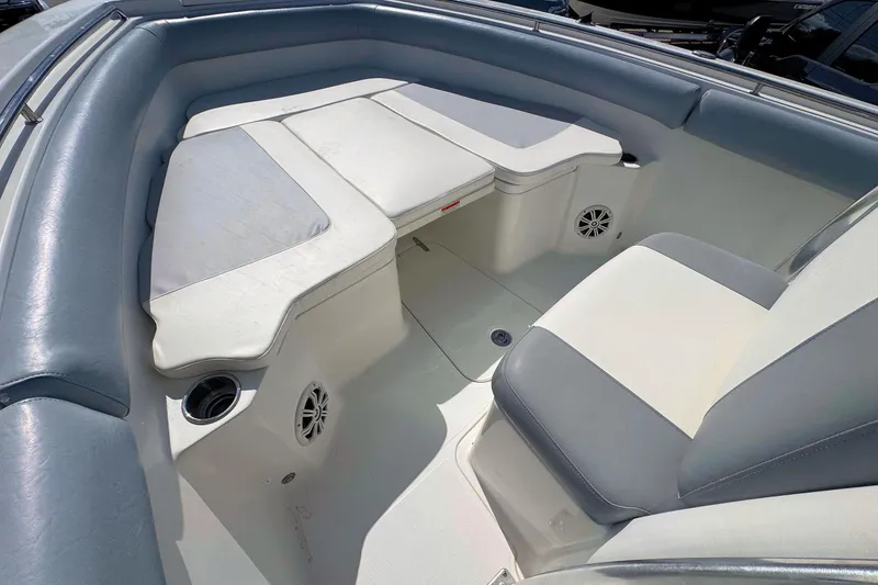 Slide: The Image of 2011 Sea Hunt Gamefish 25 boat interior with cushioned seating and cup holders. - 14