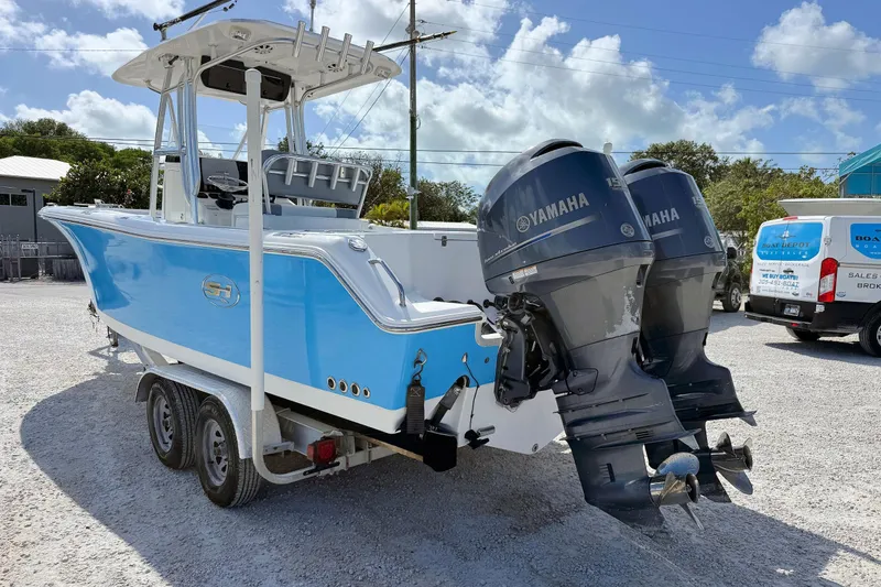 Slide: The Image of 2011 Sea Hunt Gamefish 25 boat with dual Yamaha engines on a trailer. - 3