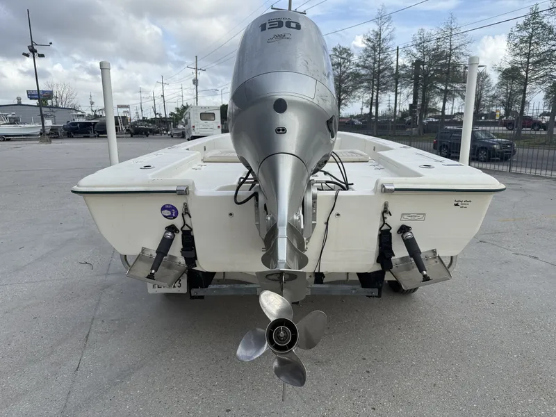 Slide: The Image of Scout 192 Sportfish 2000 with outboard motor in parking lot. - 11