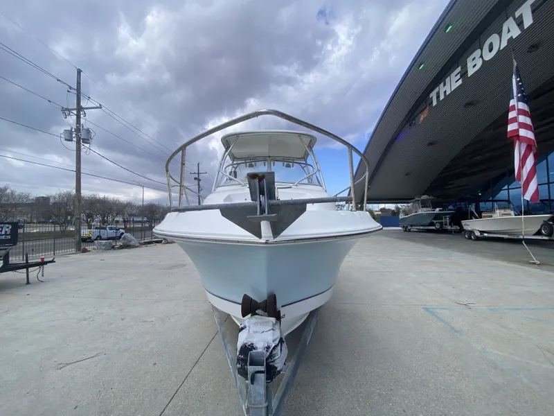 Slide: The Image of 2006 Polar 2300 WA boat in front of a boathouse. - 12