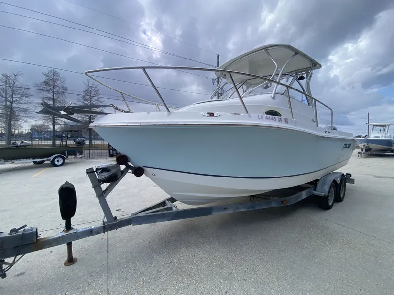 Slide: The Image of 2006 Polar 2300 WA boat on trailer under cloudy sky. - 3