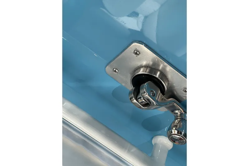 Slide: The Image of Close-up of a 2021 HCB 65 Estrella boat's stainless steel fitting on a blue surface. - 10