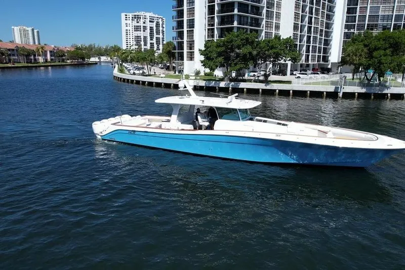 Slide: The Image of 2021 HCB 65 Estrella boat cruising near waterfront buildings. - 102