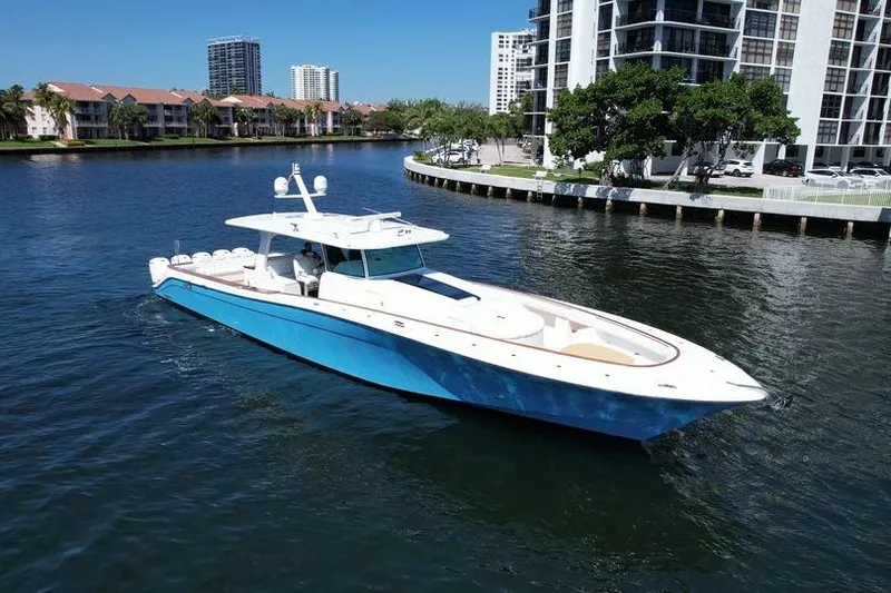 Slide: The Image of 2021 HCB 65 Estrella yacht cruising in a scenic urban waterway. - 103
