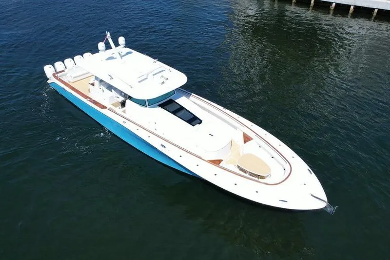 Slide: The Image of 2021 HCB 65 Estrella luxury yacht on water, showcasing sleek design and spacious deck. - 104