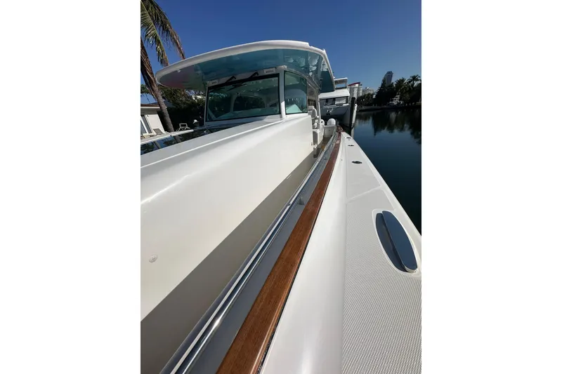 Slide: The Image of 2021 HCB 65 Estrella boat docked, showcasing sleek design and luxurious detailing. - 18