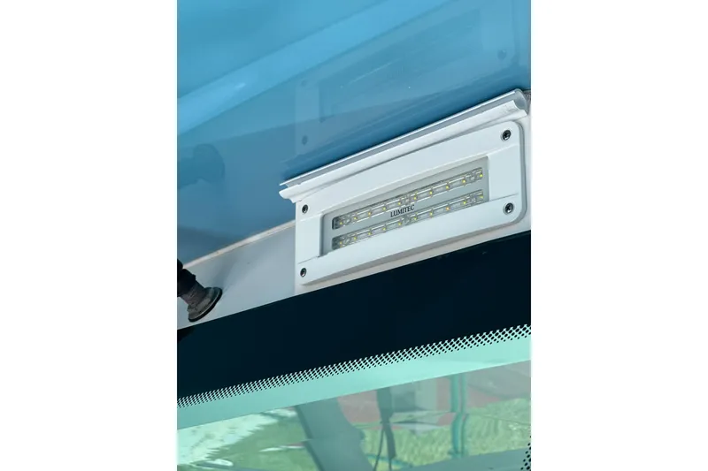Slide: The Image of LED light fixture on 2021 HCB 65 Estrella boat, featuring Lumitec branding. - 19