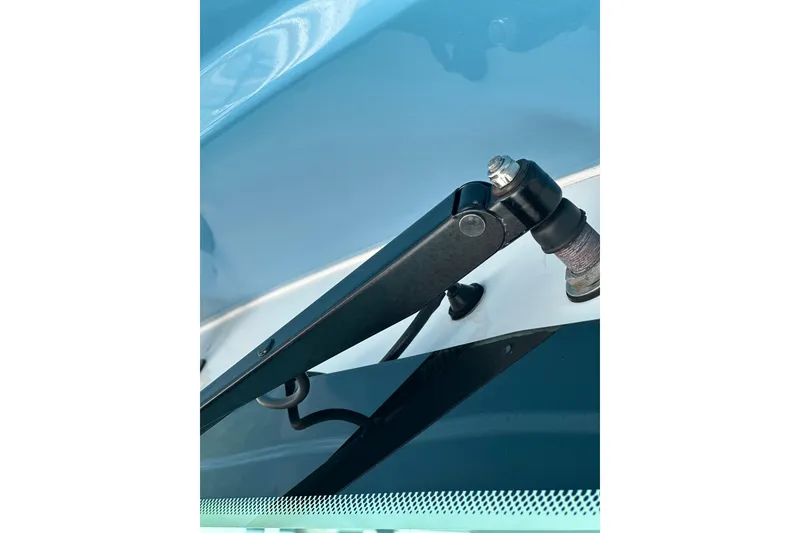 Slide: The Image of Close-up of a 2021 HCB 65 Estrella windshield wiper mechanism on a blue surface. - 20