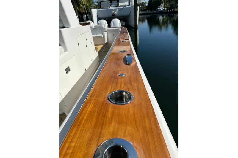 Slide: The Image of 2021 HCB 65 Estrella yacht deck with polished wood and stainless steel fixtures. - 25