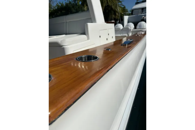 Slide: The Image of 2021 HCB 65 Estrella boat with polished wood finish and sleek design details. - 26
