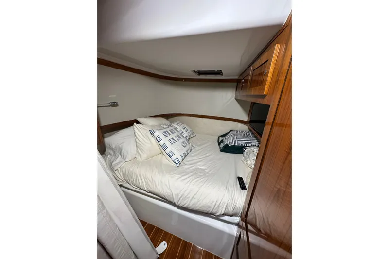 Slide: The Image of Cozy cabin interior of 2021 HCB 65 Estrella with wooden accents and plush bedding. - 37