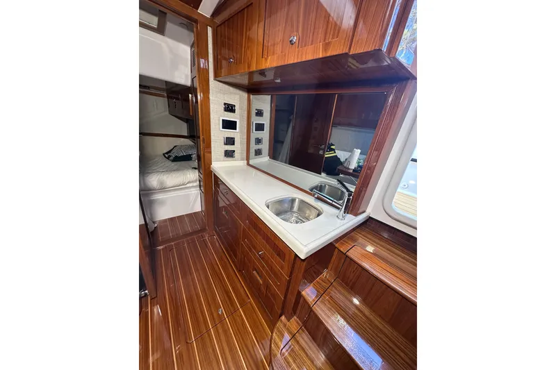 Slide: The Image of Luxurious 2021 HCB 65 Estrella yacht interior with polished wood and modern kitchenette. - 39