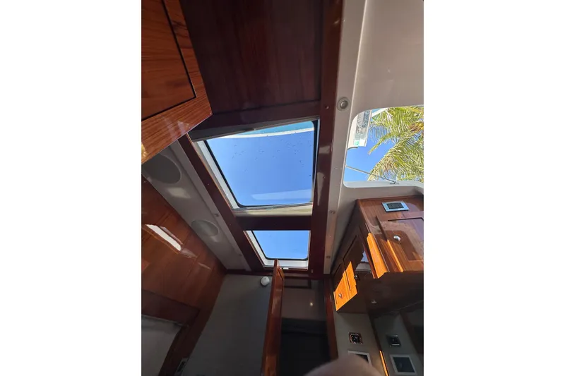Slide: The Image of Interior view of 2021 HCB 65 Estrella yacht with skylight and wooden cabinetry. - 42