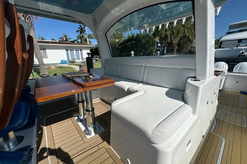 Slide: The Image of Luxurious seating area on 2021 HCB 65 Estrella yacht with wooden table. - 47