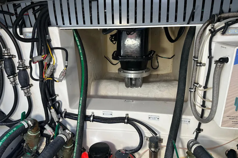 Slide: The Image of Engine compartment of a 2021 HCB 65 Estrella with visible wiring and hoses. - 59