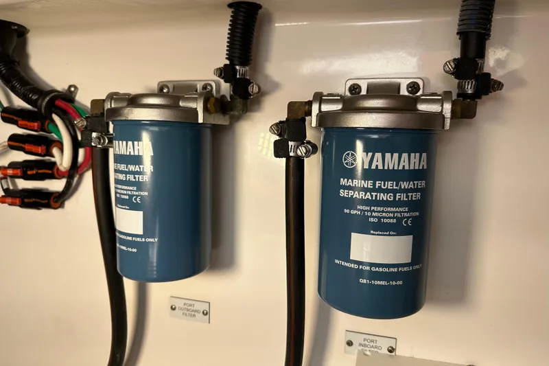 Slide: The Image of Yamaha marine fuel/water separating filters on a 2021 HCB 65 Estrella boat. - 60