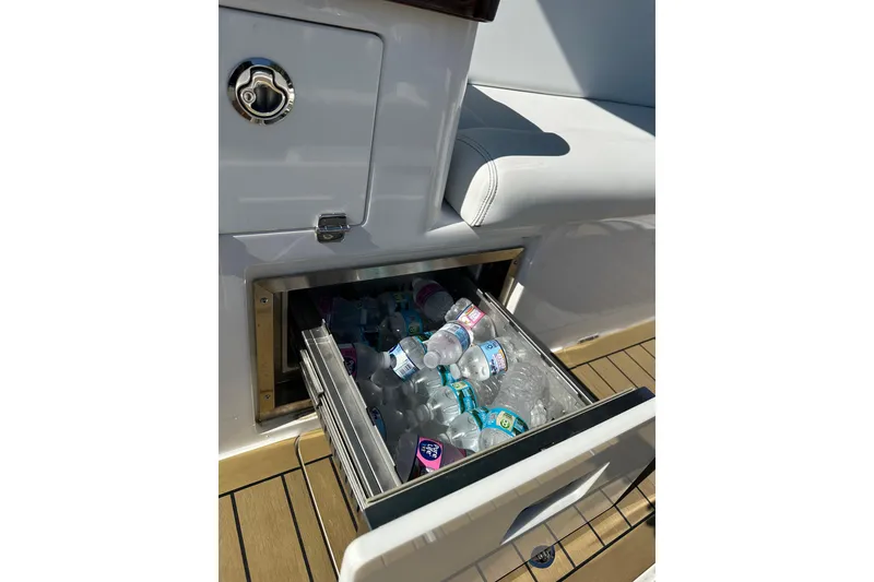 Slide: The Image of Built-in cooler drawer on 2021 HCB 65 Estrella boat, filled with bottled drinks. - 66