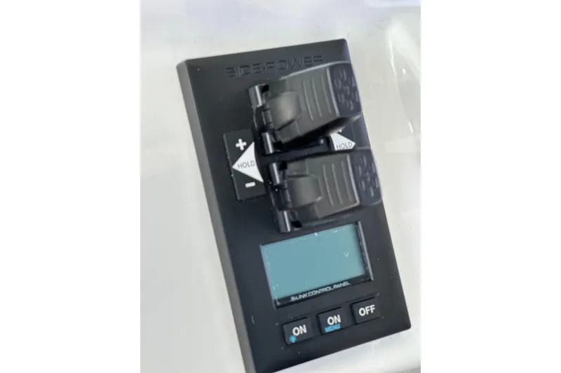 Slide: The Image of Control panel on a 2021 HCB 65 Estrella boat with switches and display. - 68
