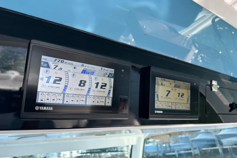 Slide: The Image of Yamaha digital displays on 2021 HCB 65 Estrella boat dashboard, showing engine metrics. - 73