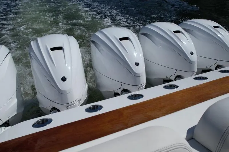 Slide: The Image of Five powerful outboard motors on a 2021 HCB 65 Estrella boat in motion. - 78