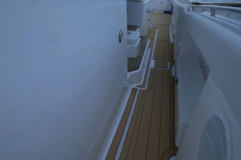 Slide: The Image of 2021 HCB 65 Estrella boat deck with sleek white and wood finish. - 80