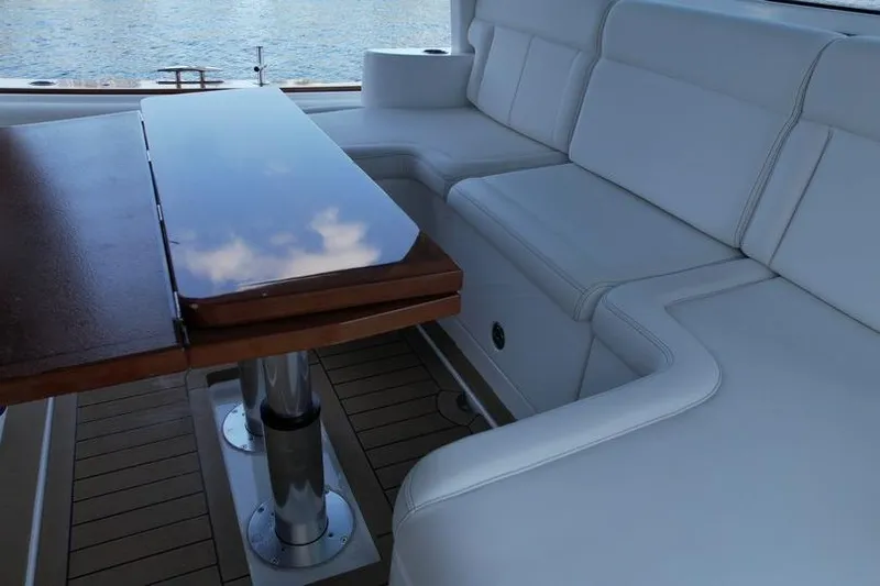 Slide: The Image of Luxurious seating and table on 2021 HCB 65 Estrella yacht, overlooking serene water. - 82