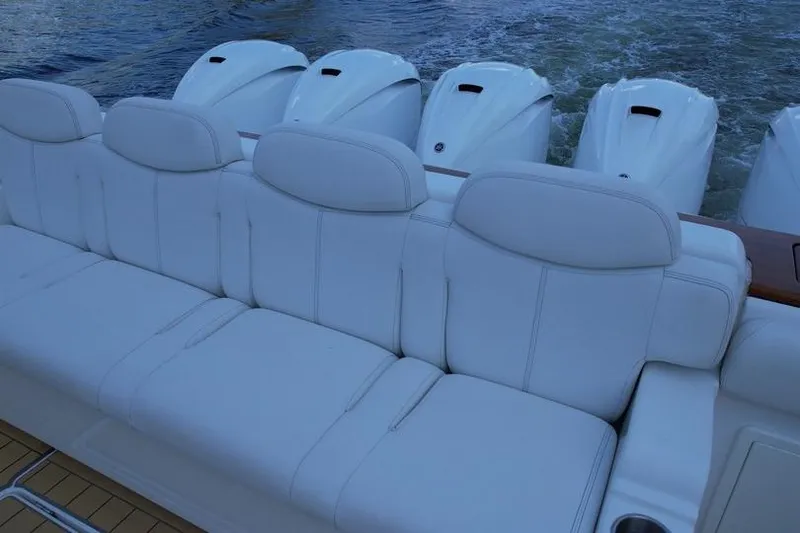 Slide: The Image of Luxurious seating on 2021 HCB 65 Estrella boat with powerful engines in background. - 85