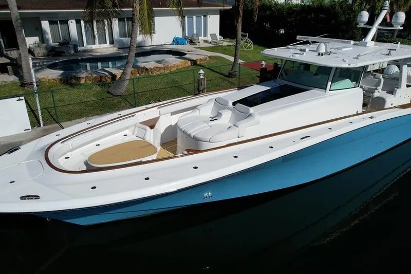 Slide: The Image of 2021 HCB 65 Estrella luxury yacht docked near a modern waterfront home. - 86