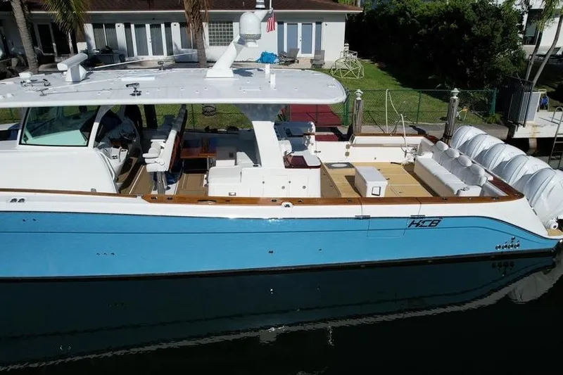 Slide: The Image of 2021 HCB 65 Estrella luxury yacht docked, featuring sleek design and spacious deck. - 87