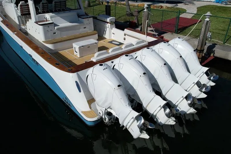 Slide: The Image of 2021 HCB 65 Estrella boat with five powerful outboard engines docked. - 90