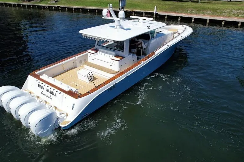 Slide: The Image of 2021 HCB 65 Estrella luxury boat cruising on calm water. - 91