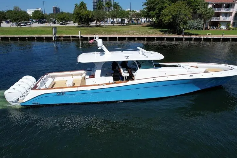 Slide: The Image of 2021 HCB 65 Estrella boat with blue hull cruising on a calm waterway. - 98