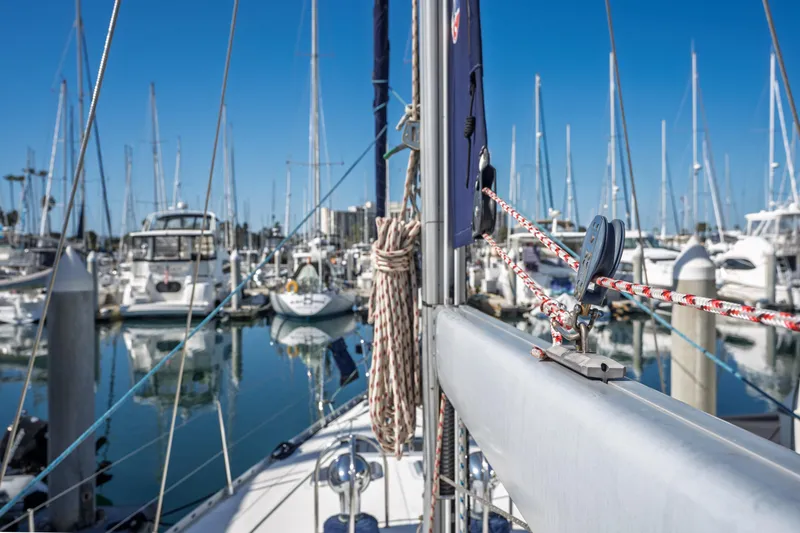 Slide: The Image of Jeanneau Sun Odyssey 45.2 sailboat in marina, showcasing rigging and masts, 2003 model. - 14