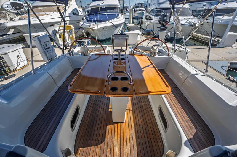 Slide: The Image of 2003 Jeanneau Sun Odyssey 45.2 sailboat cockpit with wooden table and steering wheel. - 23