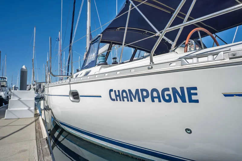 Slide: The Image of Jeanneau Sun Odyssey 45.2 sailboat named "Champagne" docked at marina, 2003 model. - 5