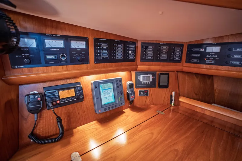 Slide: The Image of Control panel of 2003 Jeanneau Sun Odyssey 45.2 yacht, featuring navigation and communication equipment. - 51