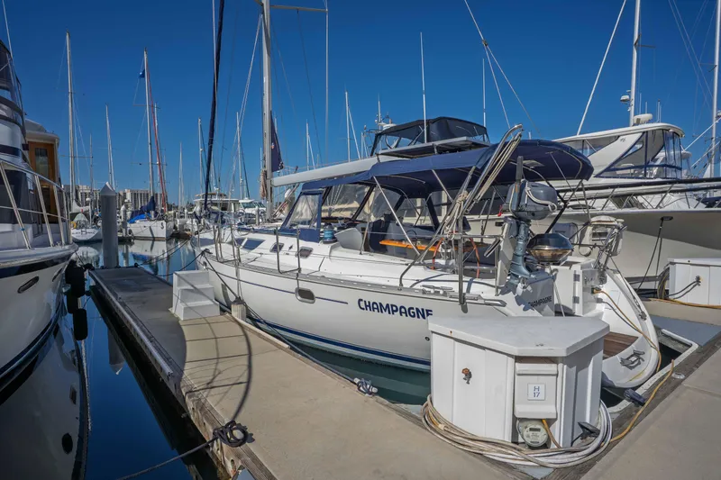 Slide: The Image of 2003 Jeanneau Sun Odyssey 45.2 sailboat docked in marina under clear blue sky. - 6