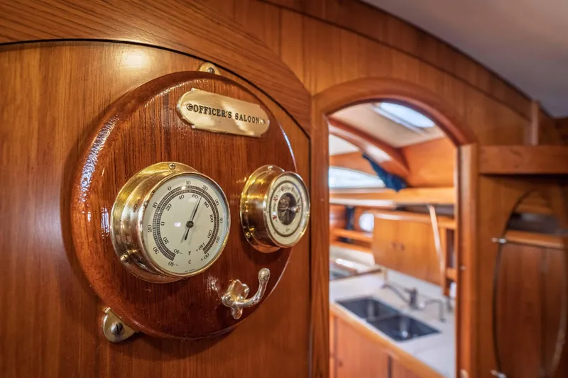 Slide: The Image of Interior of 2003 Jeanneau Sun Odyssey 45.2 yacht with classic wooden design and barometer. - 63