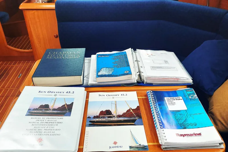 Slide: The Image of Nautical manuals and guides on a Jeanneau Sun Odyssey 45.2 yacht, 2003 model. - 78