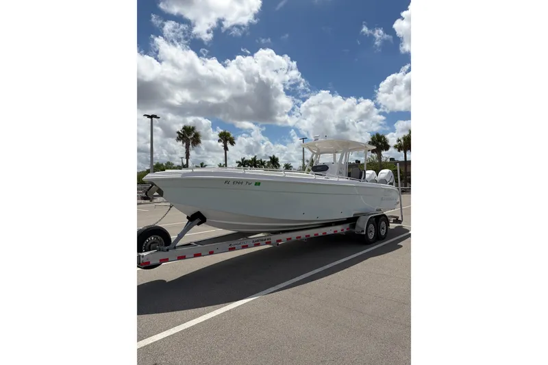 The Image of 2025 Glasstream 328 SCX boat on trailer under a partly cloudy sky. - 0