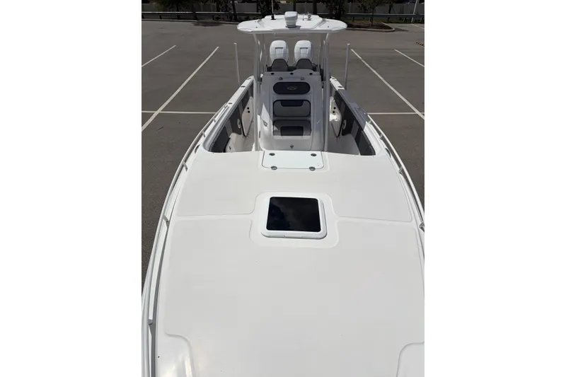 Slide: The Image of 2025 Glasstream 328 SCX boat, white deck view, parked in an empty lot. - 15