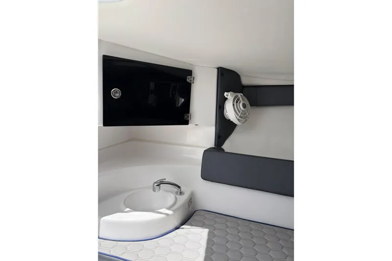 Slide: The Image of Interior of 2025 Glasstream 328 SCX boat featuring sink, storage, and seating. - 16