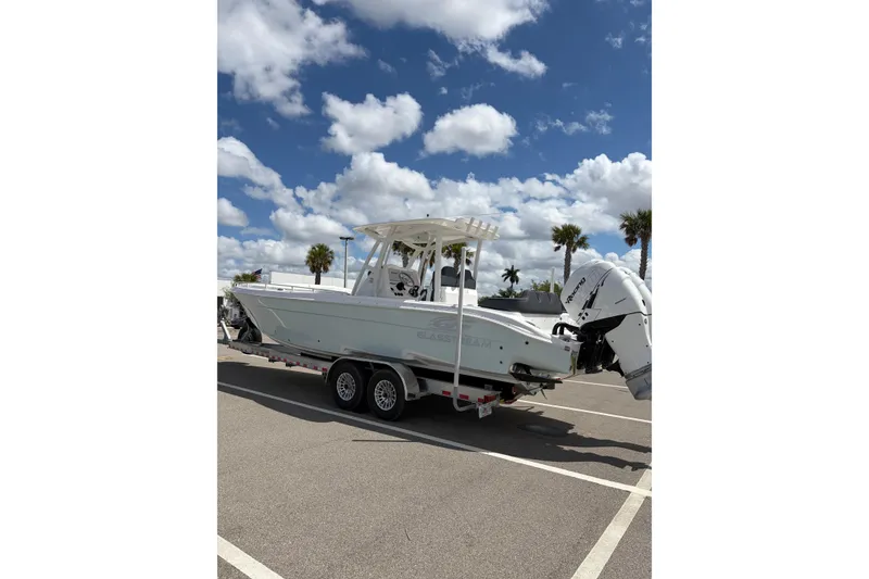 Slide: The Image of 2025 Glasstream 328 SCX boat on trailer under blue sky with clouds. - 2
