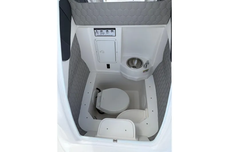 Slide: The Image of 2025 Glasstream 328 SCX boat interior with compact bathroom and sink. - 20