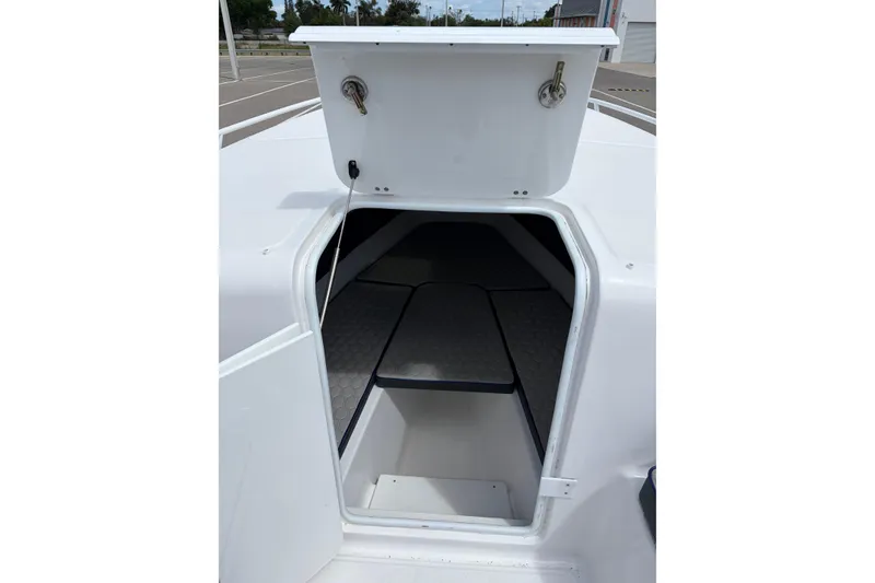 Slide: The Image of 2025 Glasstream 328 SCX boat cabin entrance with open hatch, showcasing interior seating. - 22