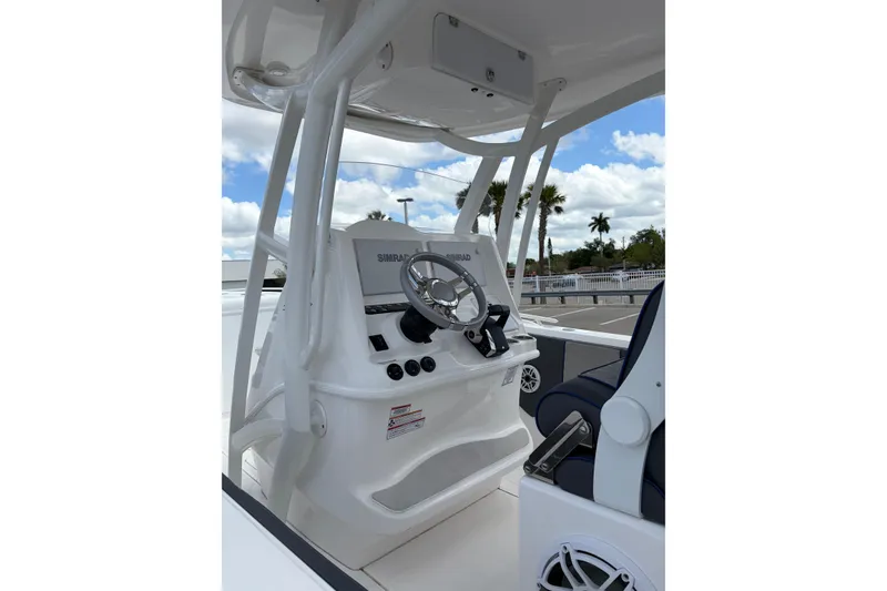 Slide: The Image of 2025 Glasstream 328 SCX boat helm with steering wheel and navigation system. - 24